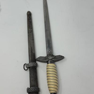 Sale Photo Thumbnail #199: Size: 15 1/4”
WWII 2nd Pattern German Luftwaffe bayonet with maker's mark on dagger 'Original Eickhorn Solingen.' Both scabbard and dagger have etched oak leaves and acorns adorning it. An eagle and two swastikas are depicted on the hilt.