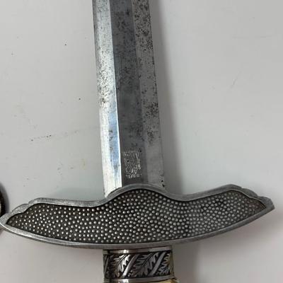 Sale Photo Thumbnail #205: Size: 15 1/4”
WWII 2nd Pattern German Luftwaffe bayonet with maker's mark on dagger 'Original Eickhorn Solingen.' Both scabbard and dagger have etched oak leaves and acorns adorning it. An eagle and two swastikas are depicted on the hilt.