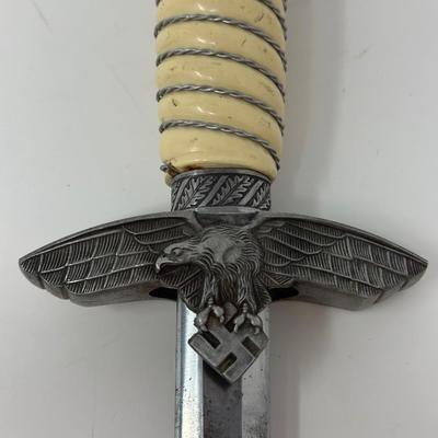 Sale Photo Thumbnail #203: Size: 15 1/4”
WWII 2nd Pattern German Luftwaffe bayonet with maker's mark on dagger 'Original Eickhorn Solingen.' Both scabbard and dagger have etched oak leaves and acorns adorning it. An eagle and two swastikas are depicted on the hilt.