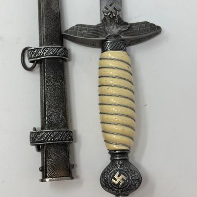 Sale Photo Thumbnail #200: Size: 15 1/4”
WWII 2nd Pattern German Luftwaffe bayonet with maker's mark on dagger 'Original Eickhorn Solingen.' Both scabbard and dagger have etched oak leaves and acorns adorning it. An eagle and two swastikas are depicted on the hilt.