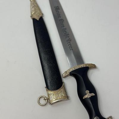 Sale Photo Thumbnail #213: Size: 14 2/2”
WWII German model SS honor dagger with the motto 'Meine Ehre Heisst Treue' etched on one side of the stainless-steel blade meaning 'Loyalty is my honor.' Etched on the reverse side of the dagger is 'In Herzlicher  Kameradschaft H. Himmler'