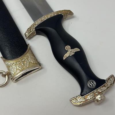 Sale Photo Thumbnail #215: Size: 14 2/2”
WWII German model SS honor dagger with the motto 'Meine Ehre Heisst Treue' etched on one side of the stainless-steel blade meaning 'Loyalty is my honor.' Etched on the reverse side of the dagger is 'In Herzlicher  Kameradschaft H. Himmler'