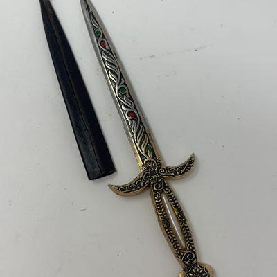 Sale Photo Thumbnail #219: Made in Spain 
Size: 6 1/4”
Antique dagger letter opener with ornate detailing.