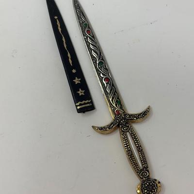 Sale Photo Thumbnail #218: Made in Spain 
Size: 6 1/4”
Antique dagger letter opener with ornate detailing.