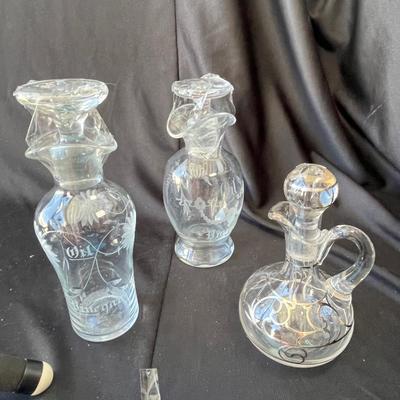 Sale Photo Thumbnail #1108: The two are salad cruets, probably Hawkes glass.  The other is silver overlay.