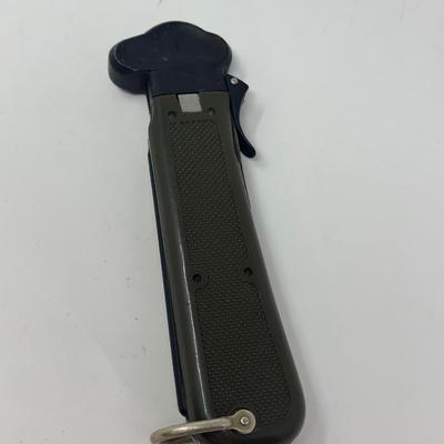 Sale Photo Thumbnail #253: Cold War era German Bundeswehr paratrooper gravity Knife. These were used by German paratroopers during WWII to free themselves in the event that their parachute and their cords got tangled. The blade is released by using the trigger on the side of the ha