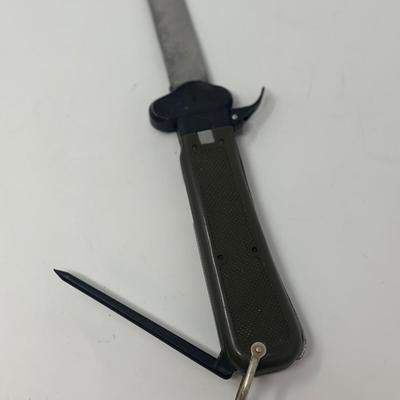 Sale Photo Thumbnail #250: Cold War era German Bundeswehr paratrooper gravity Knife. These were used by German paratroopers during WWII to free themselves in the event that their parachute and their cords got tangled. The blade is released by using the trigger on the side of the ha