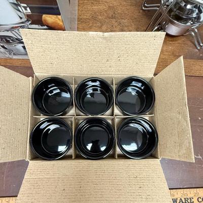 Sale Photo Thumbnail #178: 16 piece 18/8 stainless steel fondue pot set. Includes 6 forks, 6 black ceramic ramekins, splatter shield, adjustable universal burner with snuffer, stand and wood handle. In excellent condition.