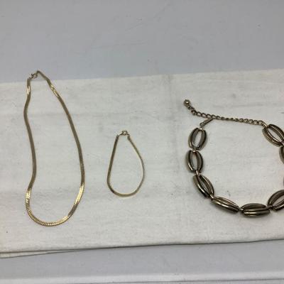 Sale Photo Thumbnail #232: You get the three pieces of jewelry.  Matching gold necklace and bracelet and a nice metal choker necklace with modern design.