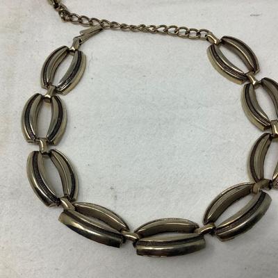 Sale Photo Thumbnail #233: You get the three pieces of jewelry.  Matching gold necklace and bracelet and a nice metal choker necklace with modern design.