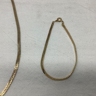 Sale Photo Thumbnail #234: You get the three pieces of jewelry.  Matching gold necklace and bracelet and a nice metal choker necklace with modern design.