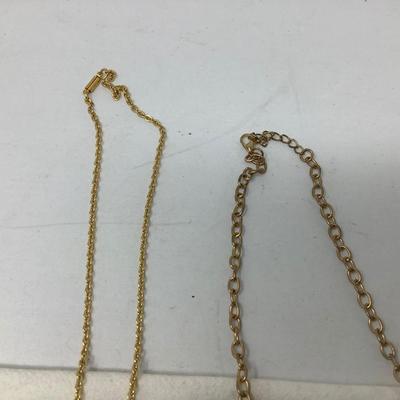 Sale Photo Thumbnail #250: You get three great gold necklaces.  Two have plastic flower pendants and the third has purple plastic gems.