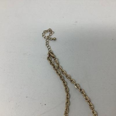 Sale Photo Thumbnail #258: Two gold necklaces one has black locket with gold inside.  The other is gold necklace with 5 charms.