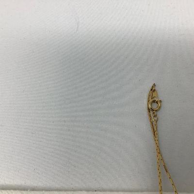Sale Photo Thumbnail #256: Two gold necklaces one has black locket with gold inside.  The other is gold necklace with 5 charms.