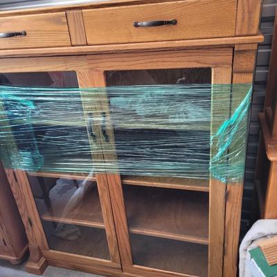 Sale Photo Thumbnail #855: Measures 48" wide, 19" deep and 57" tall. 4 shelves and two drawers, wrapped for storage and only slightly unwrapped for photos, will wrap further for transport. Oak
Doors are 21.5" wide and about 47" tall.