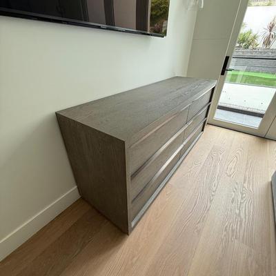 Sale Photo Thumbnail #38: The Restoration Hardware dresser from the Bezier Collection is a contemporary piece designed for the bedroom. It features a high gloss gray oak finish and is constructed from oak, offering a sleek and modern look. The dresser measures 6 feet in length, 22