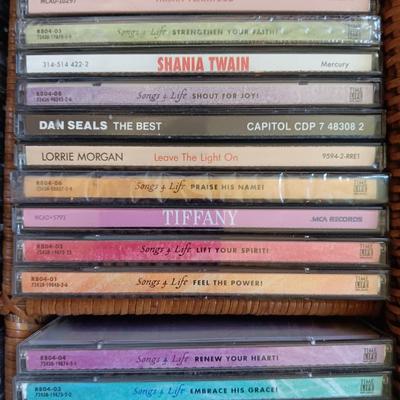 AN ASSORTMENT OF MAINLY COUNTRY WESTERN MUSIC ON CD AND A BASKET WITH A LID