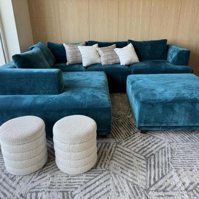 Sale Photo Thumbnail #48: The Interior Define sofa set in blue features a modern design with rich velvet upholstery, offering a spacious seating area suitable for more than six people. It includes a matching ottoman, making it ideal for living room gatherings or casual lounging. T