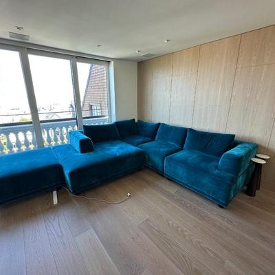 Sale Photo Thumbnail #50: The Interior Define sofa set in blue features a modern design with rich velvet upholstery, offering a spacious seating area suitable for more than six people. It includes a matching ottoman, making it ideal for living room gatherings or casual lounging. T