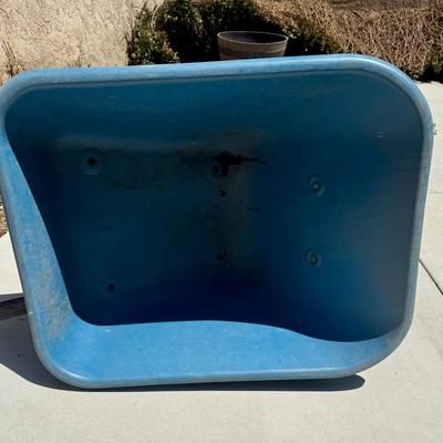 Sale Photo Thumbnail #514: Hard poly plastic 10 cubic foot bucket that doesn't rust.  Solid handles, 2 wheels, pneumatic tires hold air. Overall good used condition. Excellent for gardening, soil movement, or tasks involving wet things.