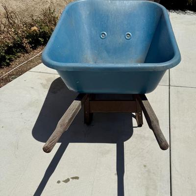 Sale Photo Thumbnail #513: Hard poly plastic 10 cubic foot bucket that doesn't rust.  Solid handles, 2 wheels, pneumatic tires hold air. Overall good used condition. Excellent for gardening, soil movement, or tasks involving wet things.