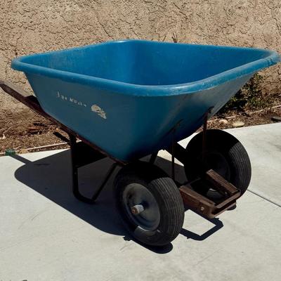Sale Photo Thumbnail #511: Hard poly plastic 10 cubic foot bucket that doesn't rust.  Solid handles, 2 wheels, pneumatic tires hold air. Overall good used condition. Excellent for gardening, soil movement, or tasks involving wet things.