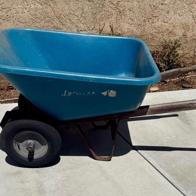 Sale Photo Thumbnail #506: Hard poly plastic 10 cubic foot bucket that doesn't rust.  Solid handles, 2 wheels, pneumatic tires hold air. Overall good used condition. Excellent for gardening, soil movement, or tasks involving wet things.