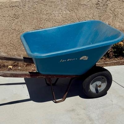 Sale Photo Thumbnail #505: Hard poly plastic 10 cubic foot bucket that doesn't rust.  Solid handles, 2 wheels, pneumatic tires hold air. Overall good used condition. Excellent for gardening, soil movement, or tasks involving wet things.
