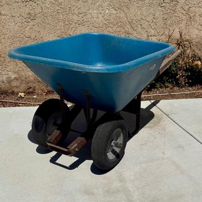Sale Photo Thumbnail #507: Hard poly plastic 10 cubic foot bucket that doesn't rust.  Solid handles, 2 wheels, pneumatic tires hold air. Overall good used condition. Excellent for gardening, soil movement, or tasks involving wet things.