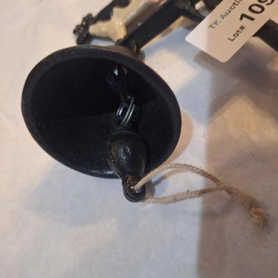 Cast iron bell with cow on top