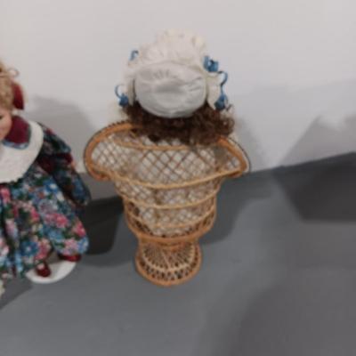 2 PORCELAIN DOLLS AND 1 MUSICAL ROTATING DOLL