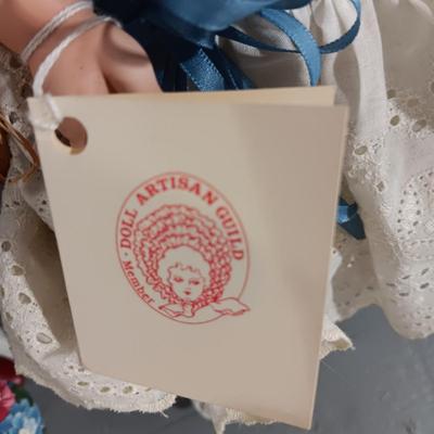 2 PORCELAIN DOLLS AND 1 MUSICAL ROTATING DOLL