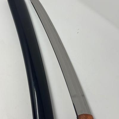 Sale Photo Thumbnail #318: Hand forged, traditionally made Japanese sword. Its name refers to the practice of wearing the sword through an obi or sash at one's side.
Overall length 24”