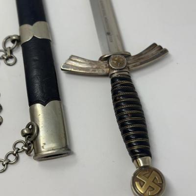 Sale Photo Thumbnail #327: Stamped Albert Kuhl, Munster I/W Essen. This WWII German Luftwaffe dagger has two swastikas depicted on the hilt.