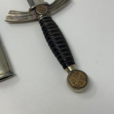 Sale Photo Thumbnail #332: Stamped Albert Kuhl, Munster I/W Essen. This WWII German Luftwaffe dagger has two swastikas depicted on the hilt.