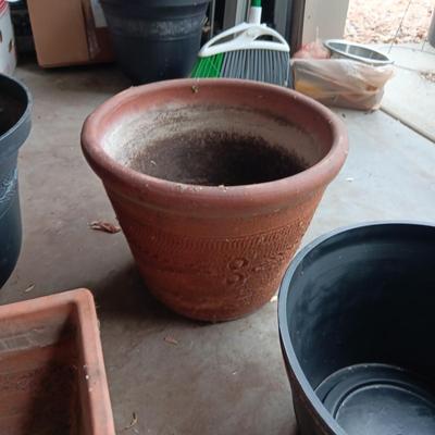 AN ASSORTMENT OF FLOWER POTS