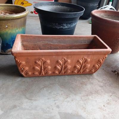 AN ASSORTMENT OF FLOWER POTS