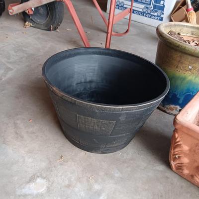 AN ASSORTMENT OF FLOWER POTS