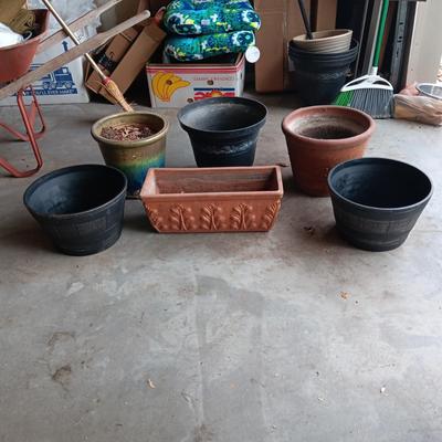 AN ASSORTMENT OF FLOWER POTS