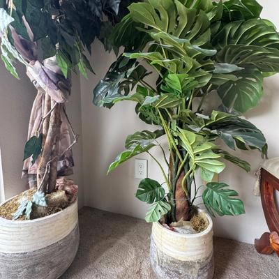 Large artificial plants in a decorative pot.