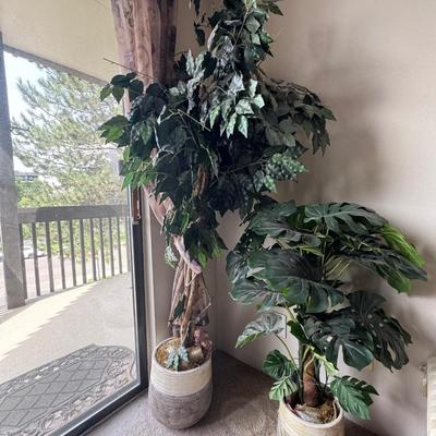 Large artificial plants in a decorative pot.