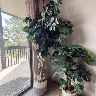 Large artificial plants in a decorative pot.