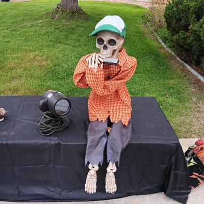 HALLOWEEN SKELETON PLAYING THE HARMONICA AND A SHOWER LIGHT
