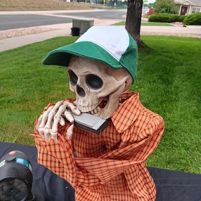 HALLOWEEN SKELETON PLAYING THE HARMONICA AND A SHOWER LIGHT