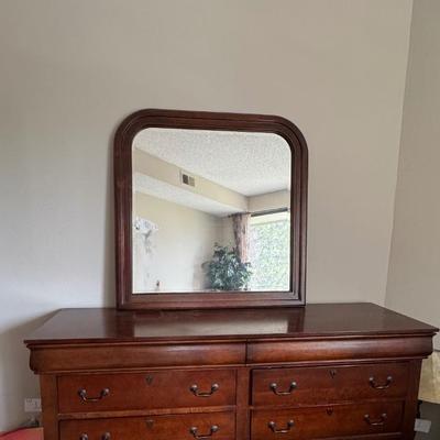 Designer dresser with six drawers and mirror.