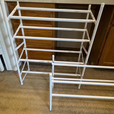 Two metal white shoe racks.