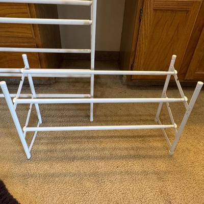 Two metal white shoe racks.