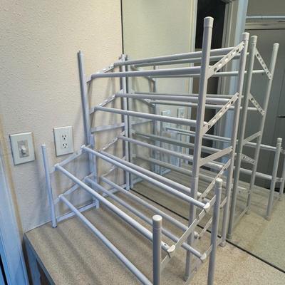 Two metal white shoe racks.