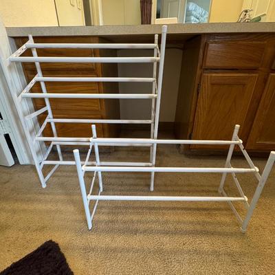 Two metal white shoe racks.