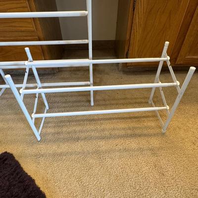 Two metal white shoe racks.